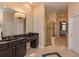 Elegant bathroom featuring granite counters, dark wood cabinetry, and a glass-enclosed shower at 1704 Kersley Cir, Lake Mary, FL 32746