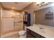 Bathroom featuring glass shower, updated vanity, decorative mirror and lighting at 1704 Kersley Cir, Lake Mary, FL 32746