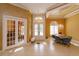 Bright foyer with chandelier, arched windows, double doors, and a formal dining space at 1704 Kersley Cir, Lake Mary, FL 32746