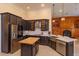 Stylish kitchen boasts dark cabinets, stainless steel appliances, and a butcher block island at 1704 Kersley Cir, Lake Mary, FL 32746
