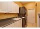 Well-lit laundry room featuring a washer and dryer, sink, countertop, and ample storage space at 1704 Kersley Cir, Lake Mary, FL 32746
