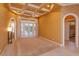 Bright living area featuring elegant tray ceilings and double doors leading to the outdoor pool at 1704 Kersley Cir, Lake Mary, FL 32746
