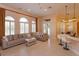 Spacious living area featuring a comfortable sectional sofa and bright windows at 1704 Kersley Cir, Lake Mary, FL 32746