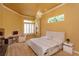 Bright main bedroom featuring large windows, elegant chandelier, and a sitting area at 1704 Kersley Cir, Lake Mary, FL 32746
