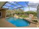 Enclosed pool area with stone waterfall features and lush landscaping for a private oasis at 1704 Kersley Cir, Lake Mary, FL 32746