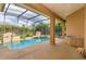 Screened lanai with an in-ground pool featuring two tiled fountains and a built in outdoor cooking space at 1704 Kersley Cir, Lake Mary, FL 32746