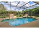 Relaxing in-ground pool within a screened enclosure that features two fountain features and lush landscaping at 1704 Kersley Cir, Lake Mary, FL 32746