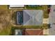 Aerial view showcases a private screened-in pool and patio with verdant backyard in a residential neighborhood at 1735 Pine Ridge Dr, Davenport, FL 33896