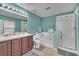 Bright bathroom features a double vanity, separate tub, enclosed shower, and refreshing color palette at 1735 Pine Ridge Dr, Davenport, FL 33896