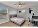 Bedroom featuring hardwood floors, light blue walls, and white trim at 1735 Pine Ridge Dr, Davenport, FL 33896