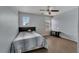 Comfortable bedroom with a dark headboard, wood-look flooring, and natural light at 1735 Pine Ridge Dr, Davenport, FL 33896