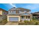 Charming two-story home featuring a covered entry, attached garage, and manicured lawn at 1735 Pine Ridge Dr, Davenport, FL 33896