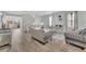Spacious living room featuring hardwood floors, grey walls, a stairway, and dining area at 1735 Pine Ridge Dr, Davenport, FL 33896