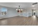 Open loft area with a chandelier, neutral walls, wood-look flooring and natural light at 1735 Pine Ridge Dr, Davenport, FL 33896