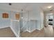 Spacious loft area featuring a chandelier, natural light and wood-look flooring at 1735 Pine Ridge Dr, Davenport, FL 33896