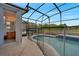 A serene screened-in pool with an adjacent bathroom offers a private outdoor retreat and convenience at 1735 Pine Ridge Dr, Davenport, FL 33896