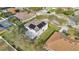 Aerial view of a home with solar panels, a screened-in pool, and a landscaped yard in a quiet neighborhood at 1827 Lindzlu St, Winter Garden, FL 34787