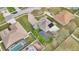 Aerial view of a house with a screened pool, solar panels, a lush lawn and well-maintained landscaping at 1827 Lindzlu St, Winter Garden, FL 34787