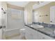This bathroom has a tub with tile surround and a vanity with storage space at 1827 Lindzlu St, Winter Garden, FL 34787