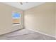 Neutral bedroom with a large window and tan carpeting at 1827 Lindzlu St, Winter Garden, FL 34787