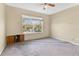 Bedroom with a ceiling fan and large window; visible wall damage at 1827 Lindzlu St, Winter Garden, FL 34787