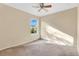 A clean bedroom featuring carpet, a ceiling fan, and a window with a view at 1827 Lindzlu St, Winter Garden, FL 34787