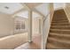 Inviting entryway featuring carpeted stairs, tiled floors, and arched openings that lead to other rooms at 1827 Lindzlu St, Winter Garden, FL 34787