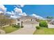 Inviting home with a three-car garage, well-manicured lawn, and lush landscaping offering curb appeal and ample parking at 1827 Lindzlu St, Winter Garden, FL 34787
