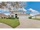 Charming two-story home featuring a three-car garage, arched entry, and well-manicured landscaping at 1827 Lindzlu St, Winter Garden, FL 34787