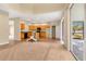 Open kitchen featuring tiled floors, wooden cabinets, a center island, and a sliding door to the outside at 1827 Lindzlu St, Winter Garden, FL 34787