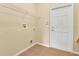 Compact laundry room with utility connections and door at 1827 Lindzlu St, Winter Garden, FL 34787