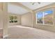 Expansive living room featuring carpeted floors, arched details, and two large windows for natural light at 1827 Lindzlu St, Winter Garden, FL 34787