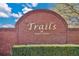 Trails of Winter Garden community sign with brick background and manicured landscaping provides an inviting neighborhood entrance at 1827 Lindzlu St, Winter Garden, FL 34787