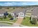 Aerial view of the home with manicured landscaping and lake views at 1880 Bonser Rd, Minneola, FL 34715