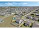 Expansive aerial view of a modern suburban neighborhood with well-maintained lawns and stylish single-Gathering homes at 1880 Bonser Rd, Minneola, FL 34715