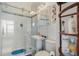 Bright bathroom with a glass-enclosed shower, pedestal sink, and white tile at 1880 Bonser Rd, Minneola, FL 34715
