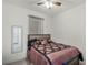 Bedroom with a patterned comforter, ceiling fan, neutral walls, and wood-look floors at 1880 Bonser Rd, Minneola, FL 34715