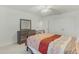Bright bedroom featuring double closets, neutral carpet, and a ceiling fan at 1880 Bonser Rd, Minneola, FL 34715