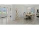 Bright dining room featuring chandelier, dining table set for six, and view of front door at 1880 Bonser Rd, Minneola, FL 34715