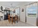 Cozy dining room with classic wood table and chairs, chandelier lighting, and decorative window treatments at 1880 Bonser Rd, Minneola, FL 34715
