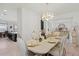 Dining room view featuring set dining table, doorway to kitchen, and elegant foyer details at 1880 Bonser Rd, Minneola, FL 34715