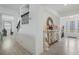 Foyer view features staircase, decorative mirror, and front door with decorative glass panels at 1880 Bonser Rd, Minneola, FL 34715
