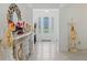 Foyer showcasing front door, decorative mirror on console, and elegant decorative lamp at 1880 Bonser Rd, Minneola, FL 34715