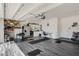 Spacious garage with gray floors, utility sink, overhead storage, and extra refrigerator at 1880 Bonser Rd, Minneola, FL 34715