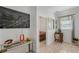 Hallway featuring modern decor, light walls, and wood-look floors leading to a bedroom and other rooms at 1880 Bonser Rd, Minneola, FL 34715