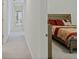 Upstairs hallway featuring neutral carpet and a bedroom at 1880 Bonser Rd, Minneola, FL 34715