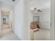 Upstairs hallway featuring neutral carpet and views into bedrooms and a bathroom at 1880 Bonser Rd, Minneola, FL 34715