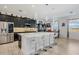 Modern kitchen features black cabinets, stainless steel appliances, and a large center island with seating at 1880 Bonser Rd, Minneola, FL 34715