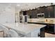 Bright kitchen featuring a center island, stainless steel appliances, ample cabinet space, and light countertops at 1880 Bonser Rd, Minneola, FL 34715