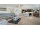 Open-concept area with kitchen, dining and living areas featuring modern decor and light-colored floors at 1880 Bonser Rd, Minneola, FL 34715